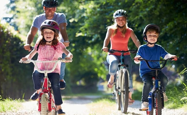family with children cycling